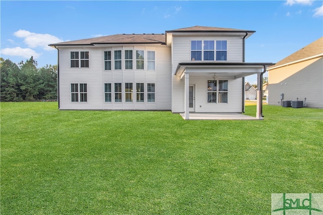 rear view of house featuring central AC unit, a lawn, and a patio area