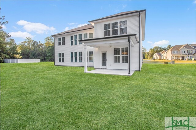 back of property featuring a lawn, ceiling fan, and a patio area