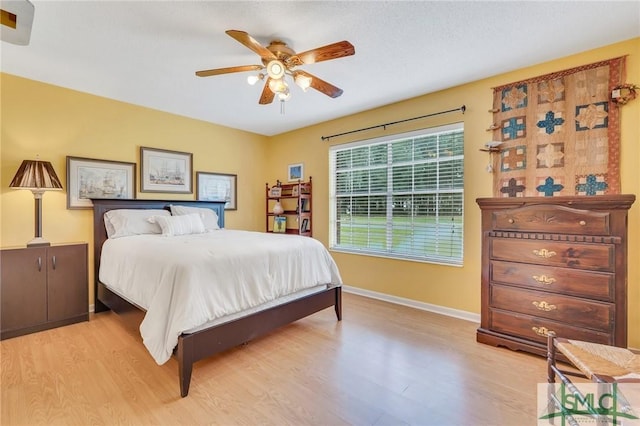 bedroom featuring light wood-type flooring and ceiling fan