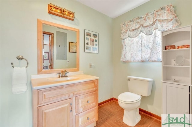 bathroom with vanity, electric panel, and toilet