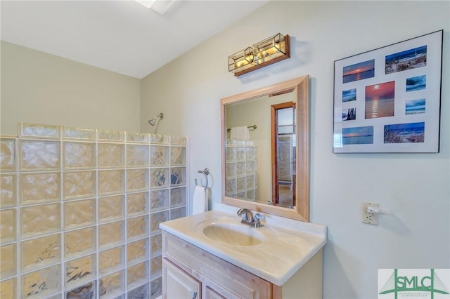 bathroom with vanity and a shower