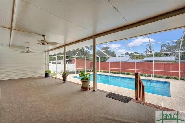 view of pool featuring ceiling fan, a patio, and glass enclosure