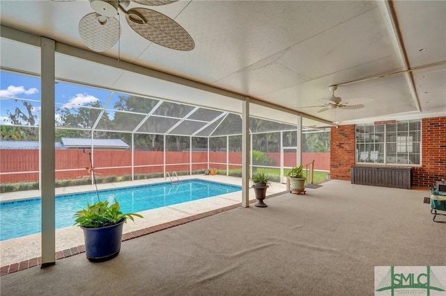 view of pool featuring ceiling fan, a patio, and glass enclosure