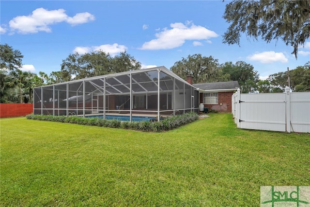 view of yard with glass enclosure and a fenced in pool