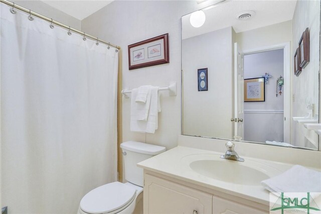 bathroom featuring vanity and toilet