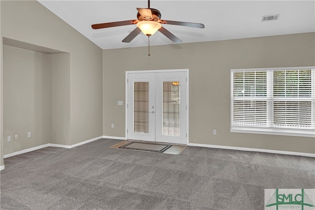 carpeted empty room featuring ceiling fan, french doors, and lofted ceiling