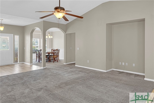 unfurnished living room with carpet floors, ceiling fan, and lofted ceiling