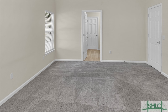 unfurnished bedroom featuring light carpet