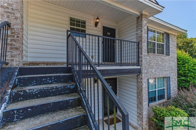 view of exterior entry with brick siding