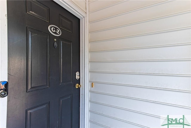 view of exterior entry with a garage