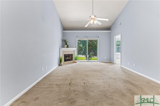 unfurnished living room with light colored carpet, visible vents, a tiled fireplace, ceiling fan, and baseboards