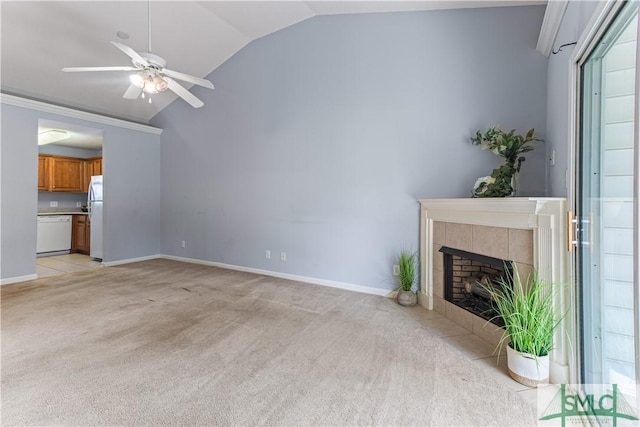 unfurnished living room with a ceiling fan, a tile fireplace, light colored carpet, and lofted ceiling