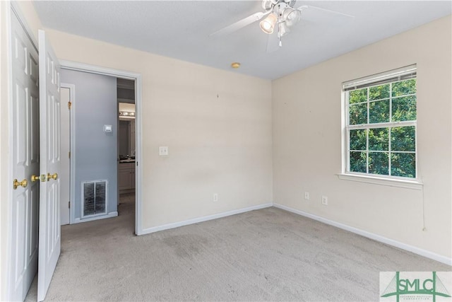 unfurnished bedroom featuring light carpet, visible vents, and baseboards