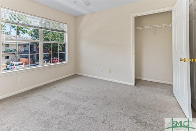 unfurnished bedroom with a closet, carpet flooring, and baseboards