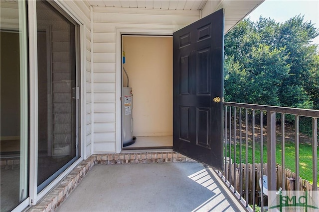 entrance to property with water heater and a balcony