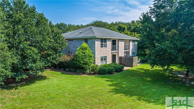 view of side of home featuring a yard and brick siding