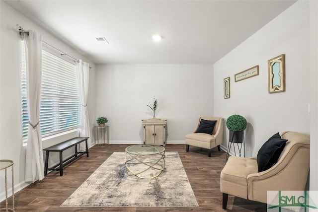 living area featuring dark wood-style floors, visible vents, and baseboards