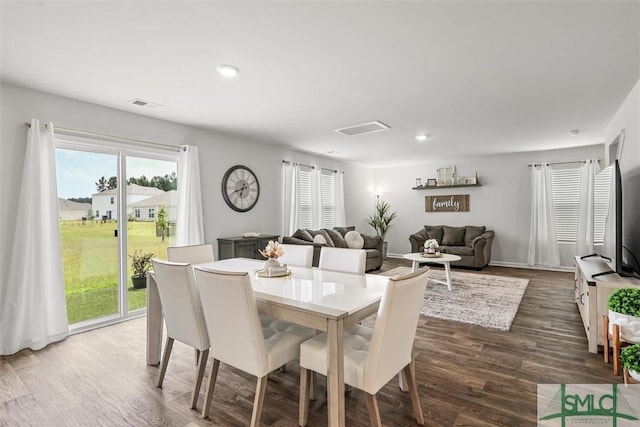 dining space featuring visible vents, dark wood-style flooring, and recessed lighting