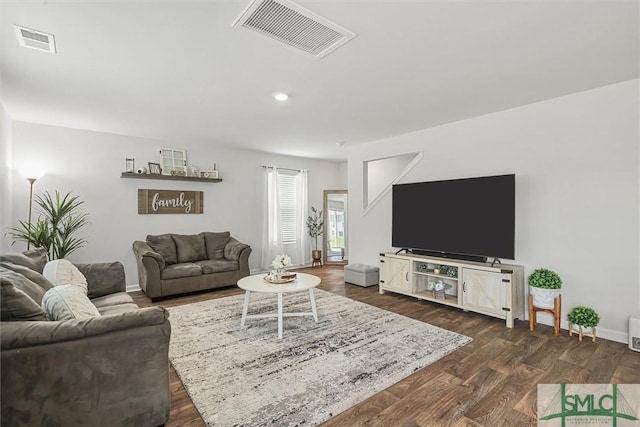 living room featuring baseboards, visible vents, dark wood-style flooring, and recessed lighting