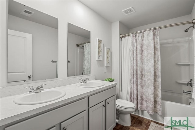 bathroom featuring shower / tub combo, visible vents, and a sink