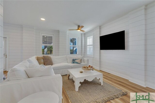 living room featuring ceiling fan and light hardwood / wood-style floors