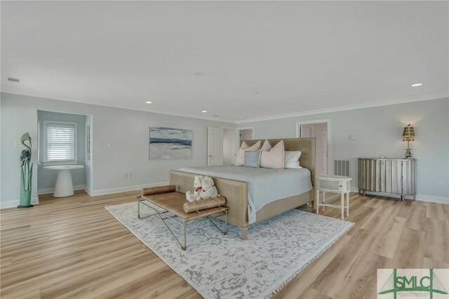 bedroom with light hardwood / wood-style flooring and ornamental molding