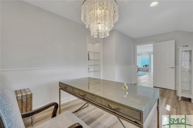 dining room with light wood-type flooring and a notable chandelier