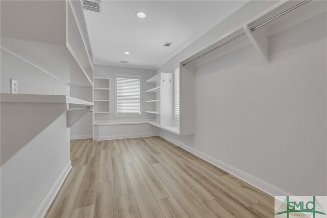 spacious closet featuring light hardwood / wood-style floors