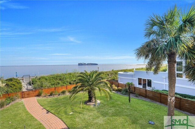 exterior space featuring a yard and a water view