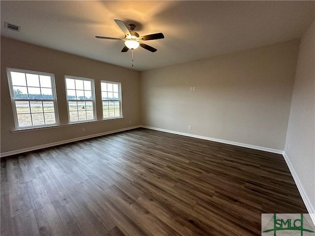 spare room featuring ceiling fan and dark hardwood / wood-style floors