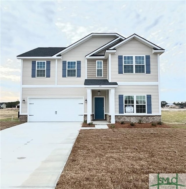 view of front facade featuring a front yard and a garage