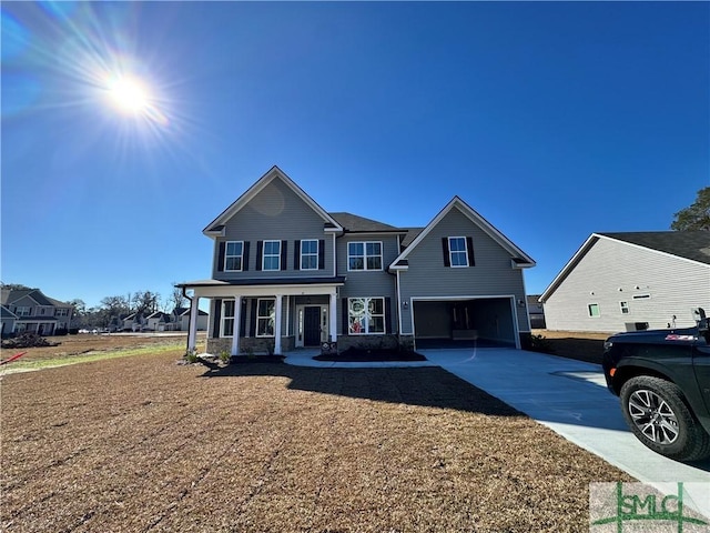 view of front of property featuring covered porch and a garage