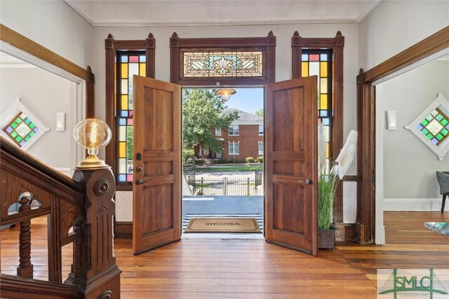 entryway featuring hardwood / wood-style floors and ornamental molding