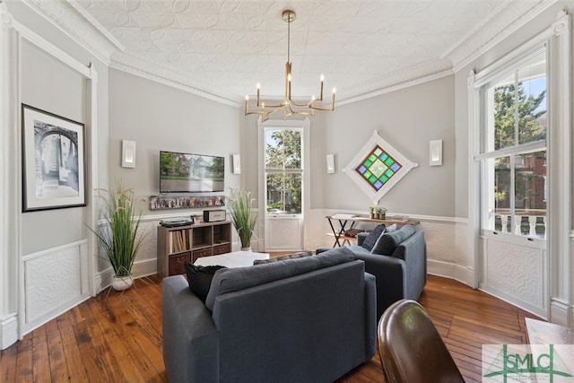 living room with a wealth of natural light, dark wood-type flooring, and crown molding