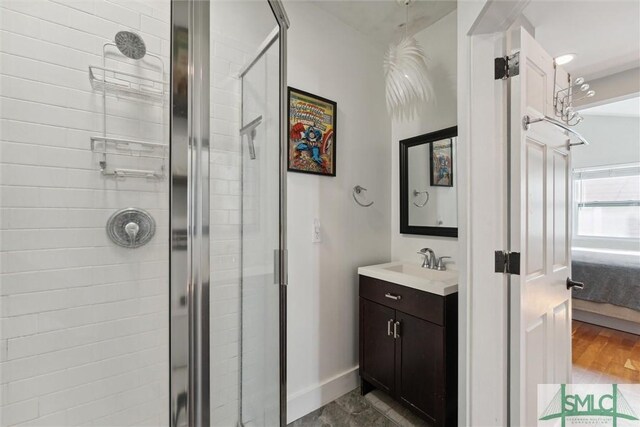 bathroom featuring hardwood / wood-style flooring, vanity, and walk in shower