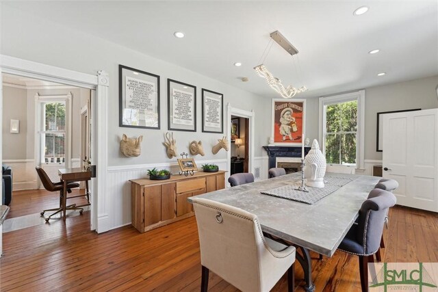 dining space with a fireplace and dark wood-type flooring