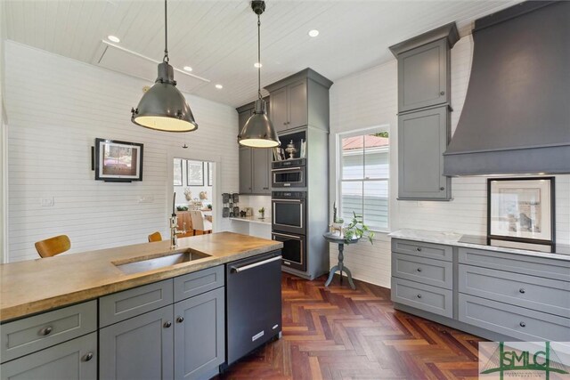 kitchen featuring appliances with stainless steel finishes, tasteful backsplash, pendant lighting, dark parquet floors, and custom exhaust hood