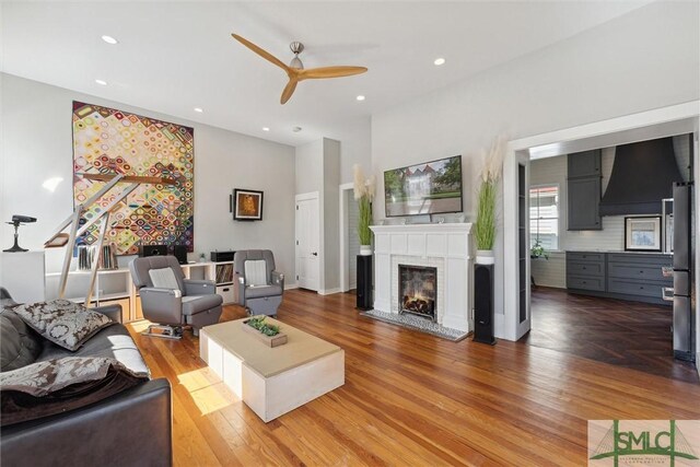 living room featuring ceiling fan and wood-type flooring