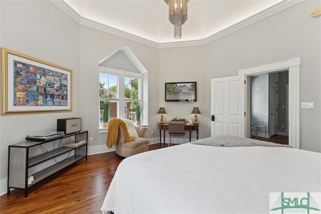 bedroom featuring an inviting chandelier, ornamental molding, and hardwood / wood-style flooring