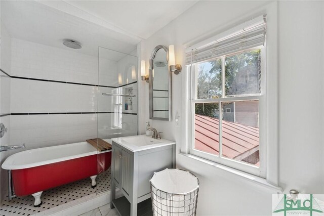 bathroom with a bathtub, tile patterned floors, and vanity