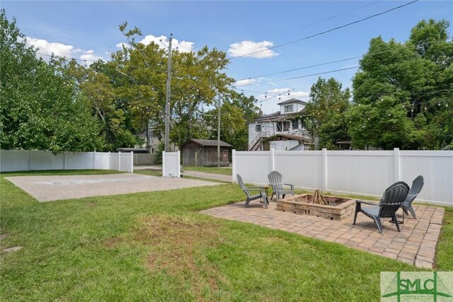 view of yard featuring a patio and a fire pit