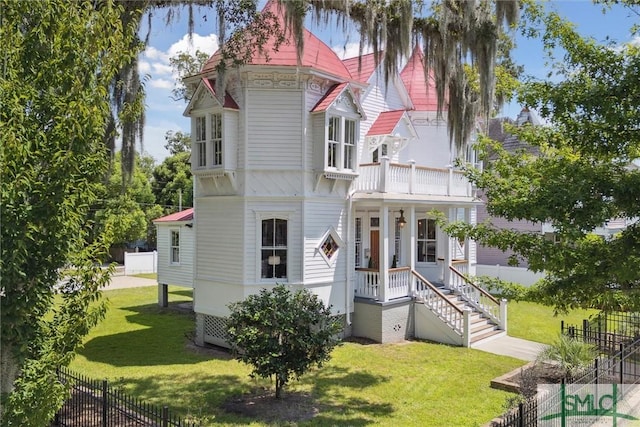 rear view of house featuring a lawn