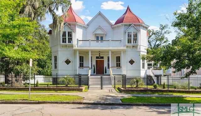 victorian house featuring a balcony and a porch