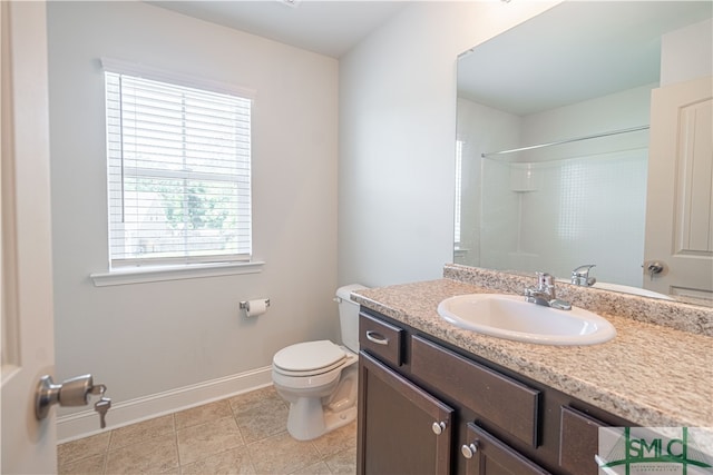 bathroom with tile patterned flooring, toilet, and vanity