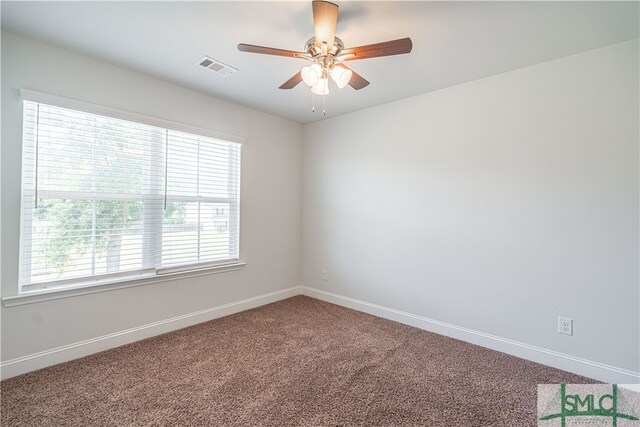 spare room featuring carpet floors, ceiling fan, and plenty of natural light