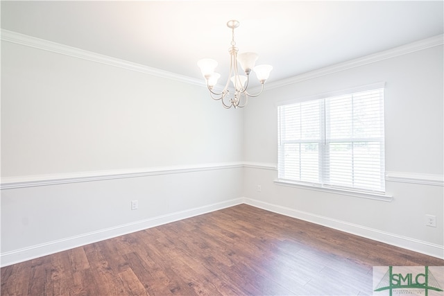 unfurnished room with ornamental molding, an inviting chandelier, and wood-type flooring