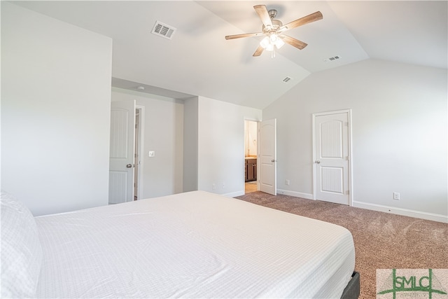 carpeted bedroom with ceiling fan, connected bathroom, and lofted ceiling