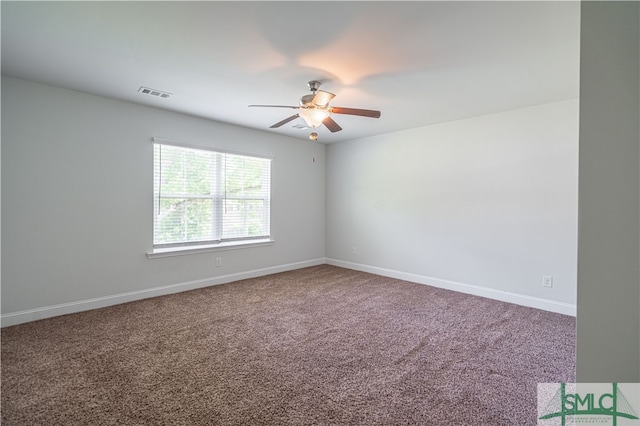 carpeted empty room featuring ceiling fan