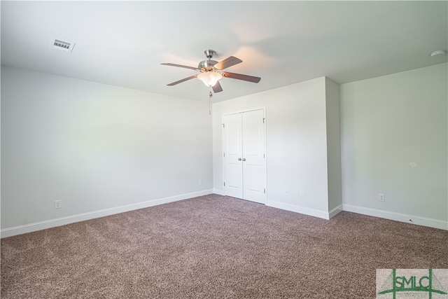 unfurnished bedroom with ceiling fan, a closet, and carpet flooring