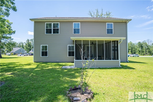 rear view of property with a yard and a sunroom